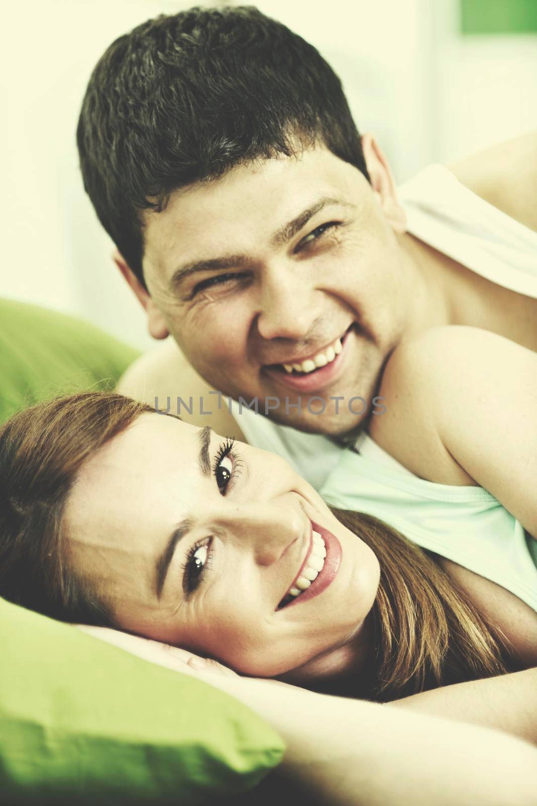 happy young couple in bed at morning