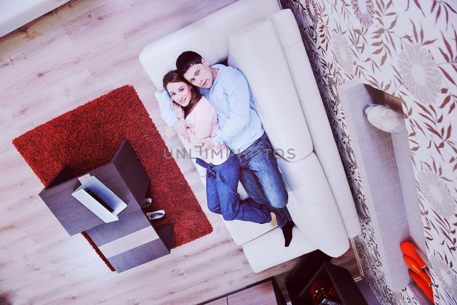 happy young couple relax at home in modern and bright living room