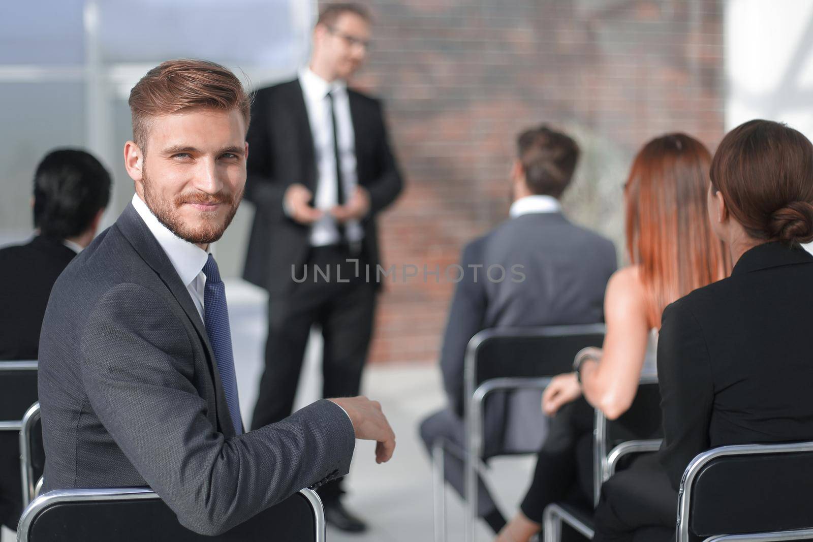 young businessman sitting in the conference room by asdf