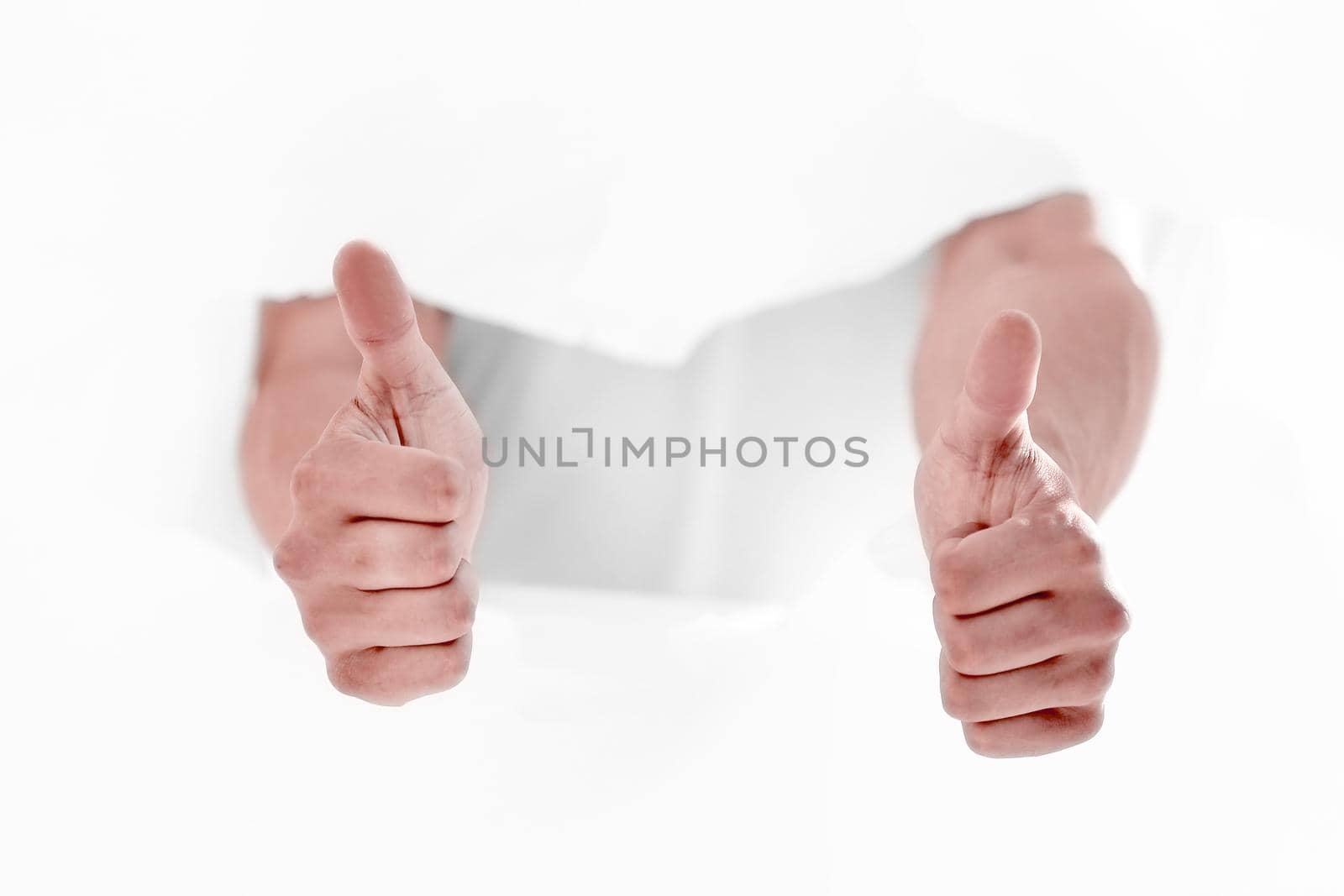 man breaking through the paper wall and showing thumbs up. by asdf