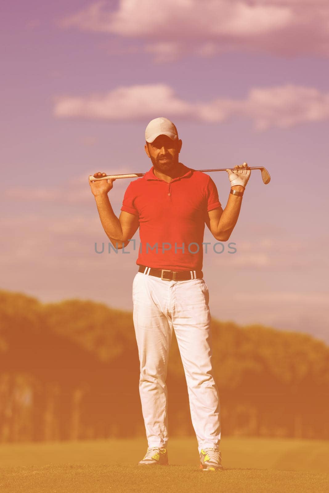 handsome middle eastern golf player portrait at course by dotshock