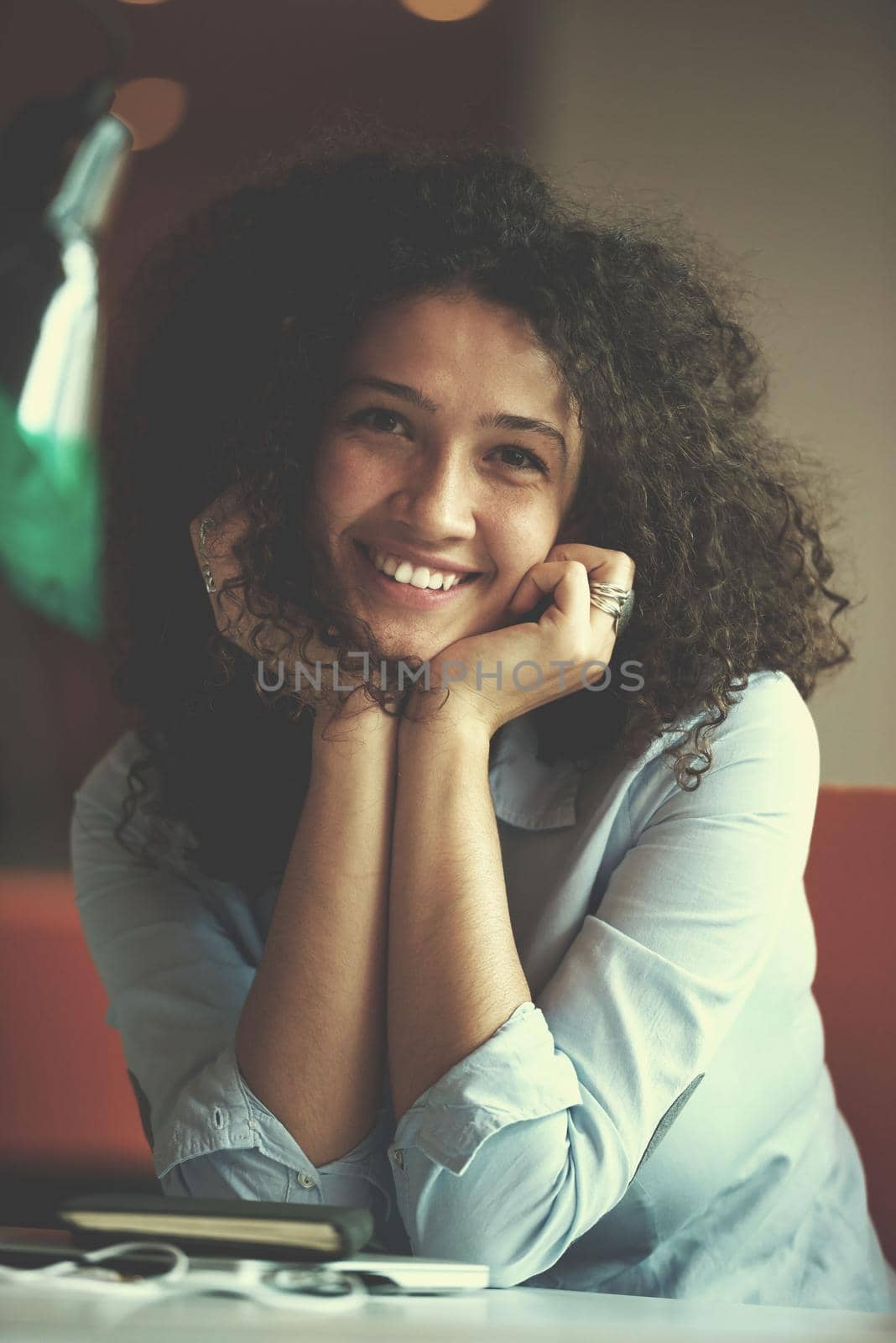 happy young  business woman with curly hairstyle in the modern office