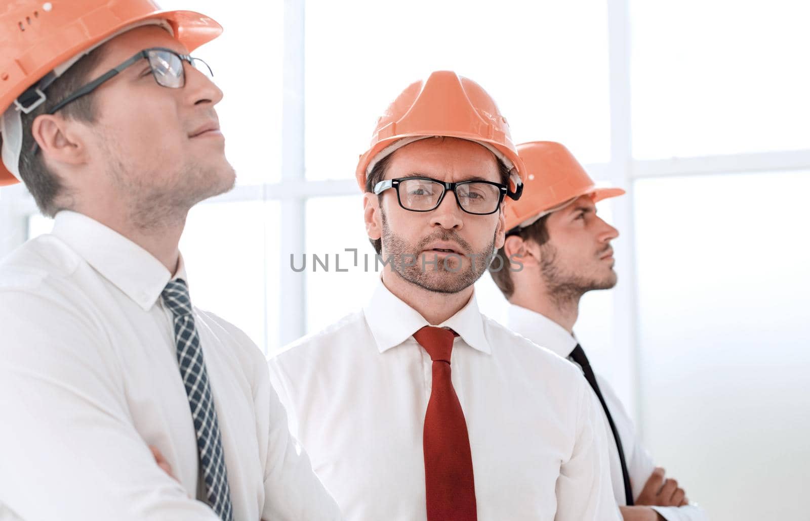 close up.background image of a group of business people in protective helmets