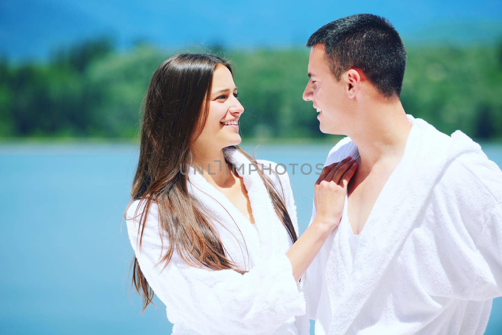 Romantic young couple spending time together and relaxing on yacht