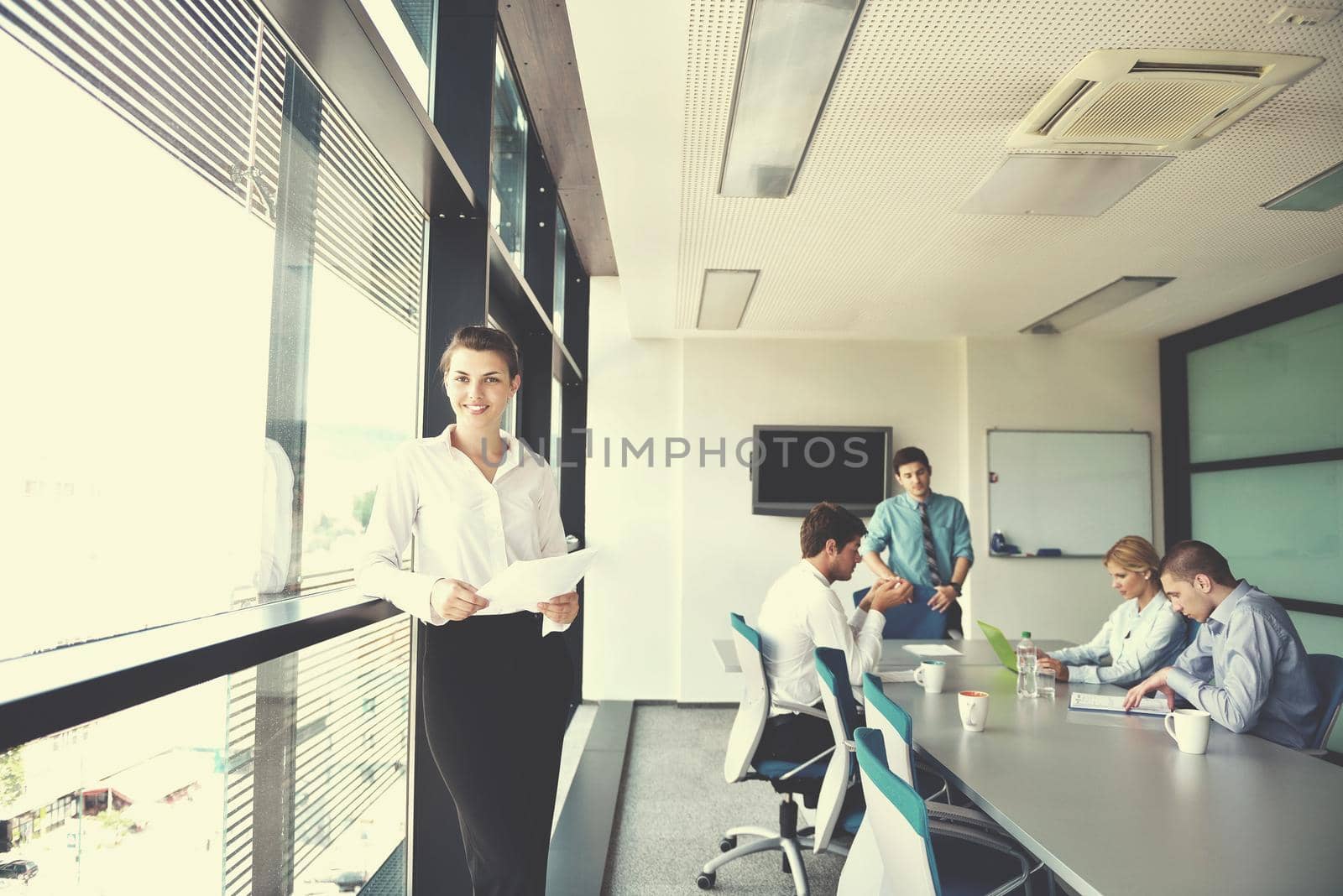 business woman  with her staff,  people group in background at modern bright office indoors