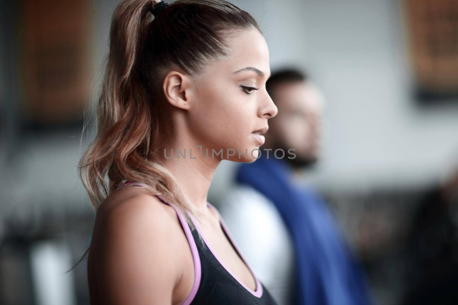 close up. attractive young woman running on a treadmill. by asdf