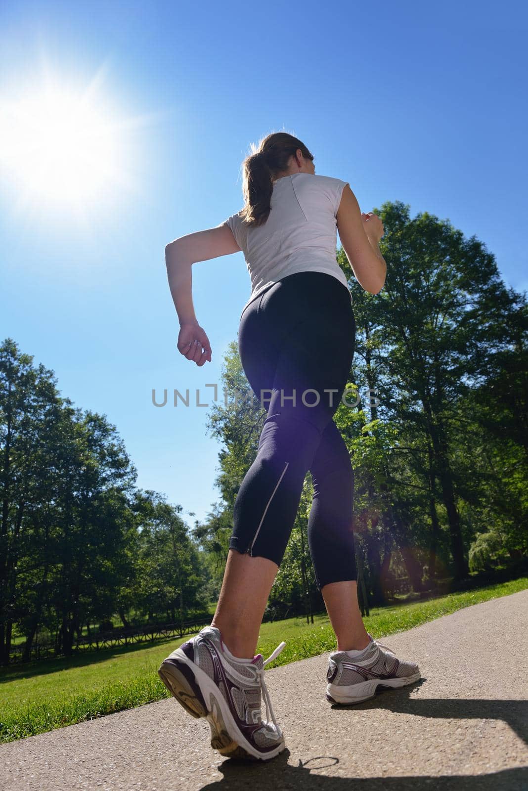 Young beautiful  woman jogging at morning in park by dotshock