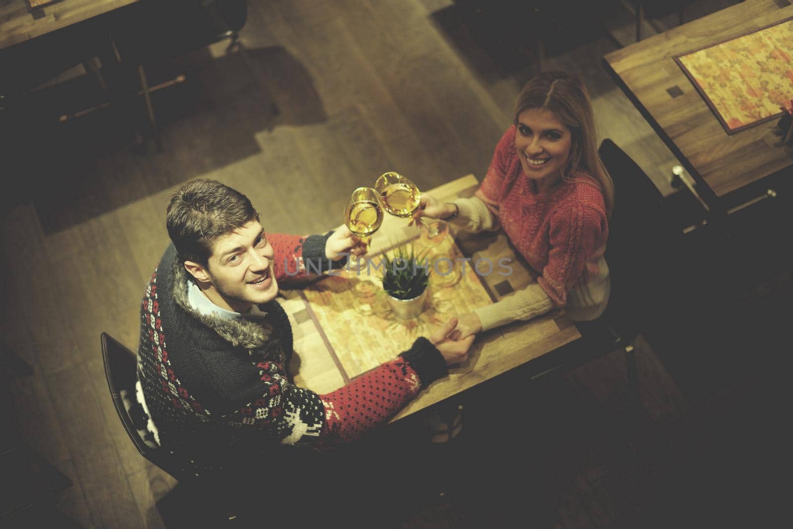 romantic evening date in restaurant  happy young couple with wine glass tea and cake