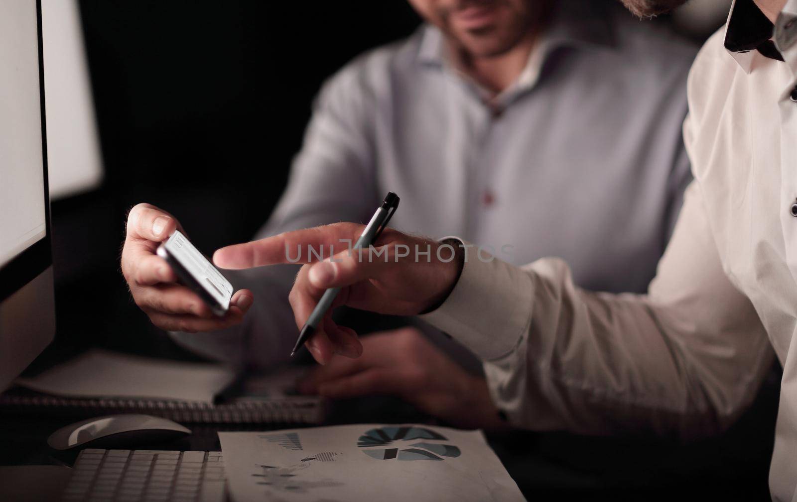 close up.businessman using smartphone to check financial data.business and technology