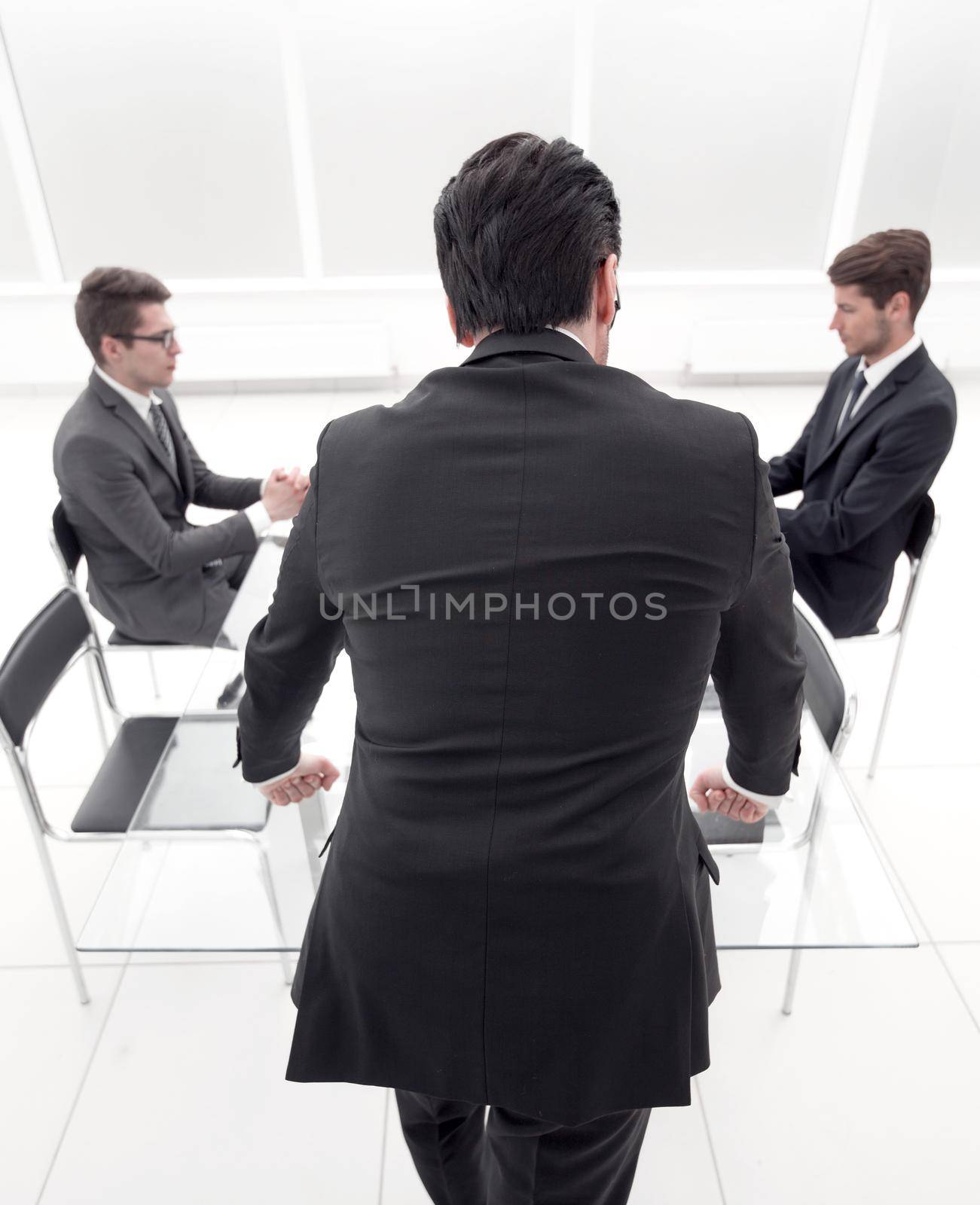 rear view.businessman standing in the conference room .business concept