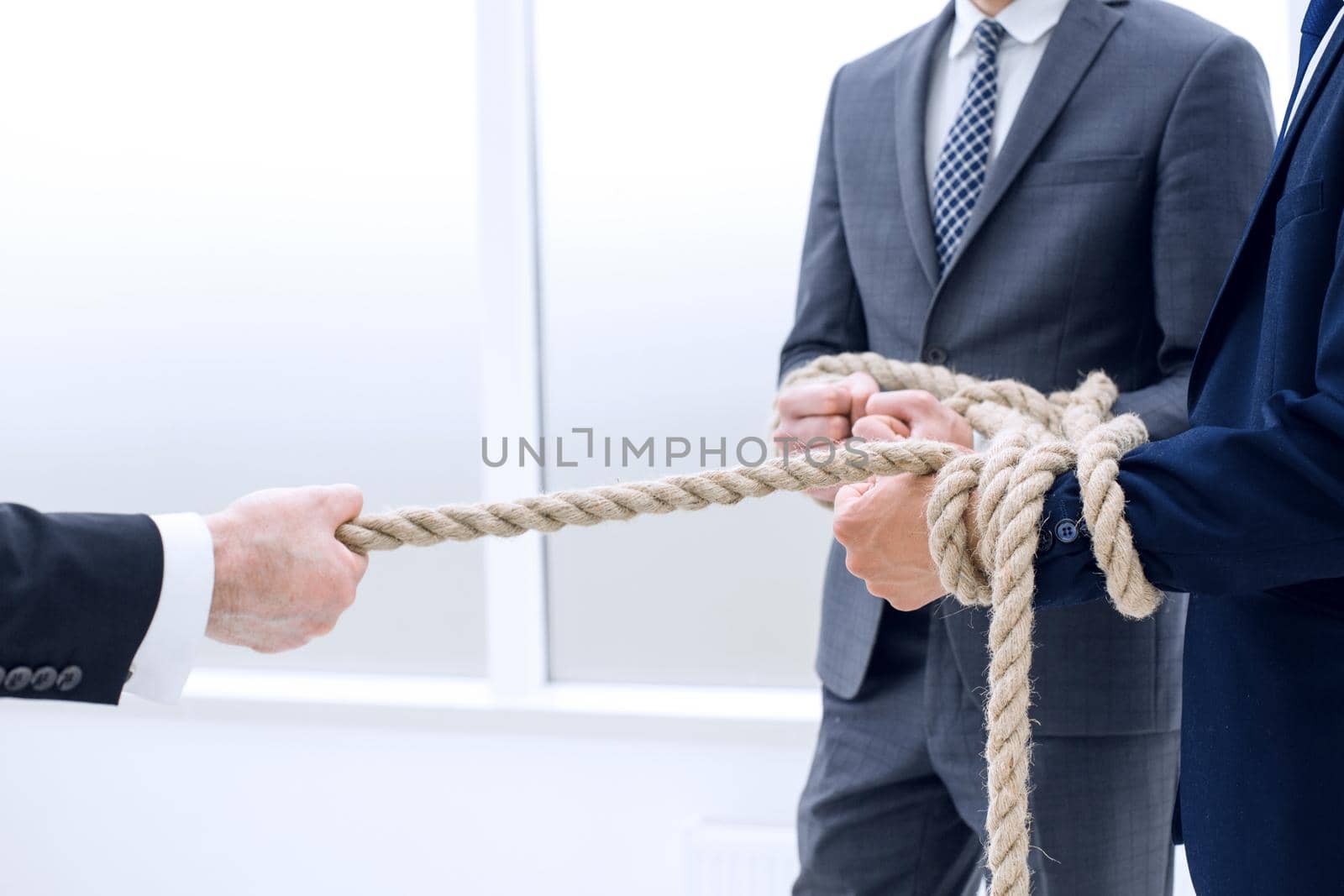 close up.businessman drags his business team by the rope .photo with copy space