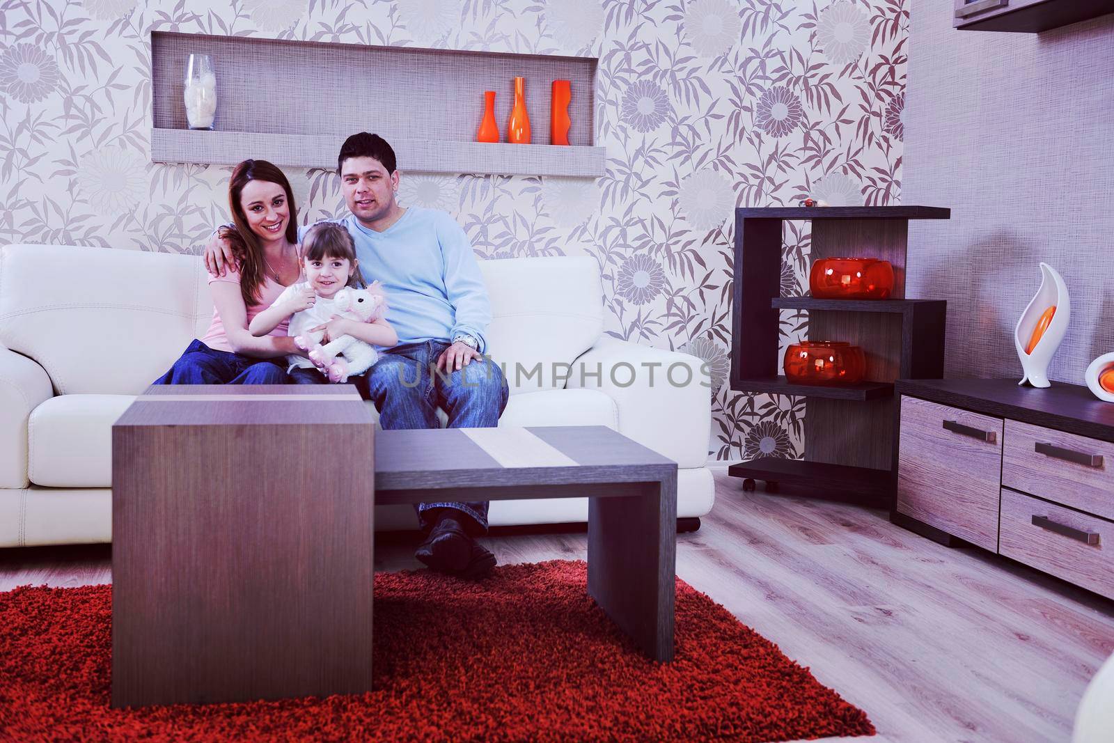 happy young family at home by dotshock