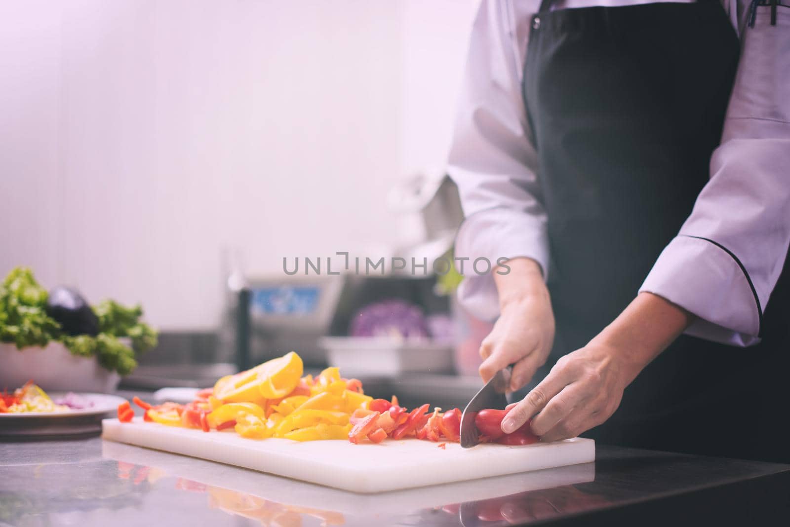 Chef cutting fresh and delicious vegetables for cooking or salad