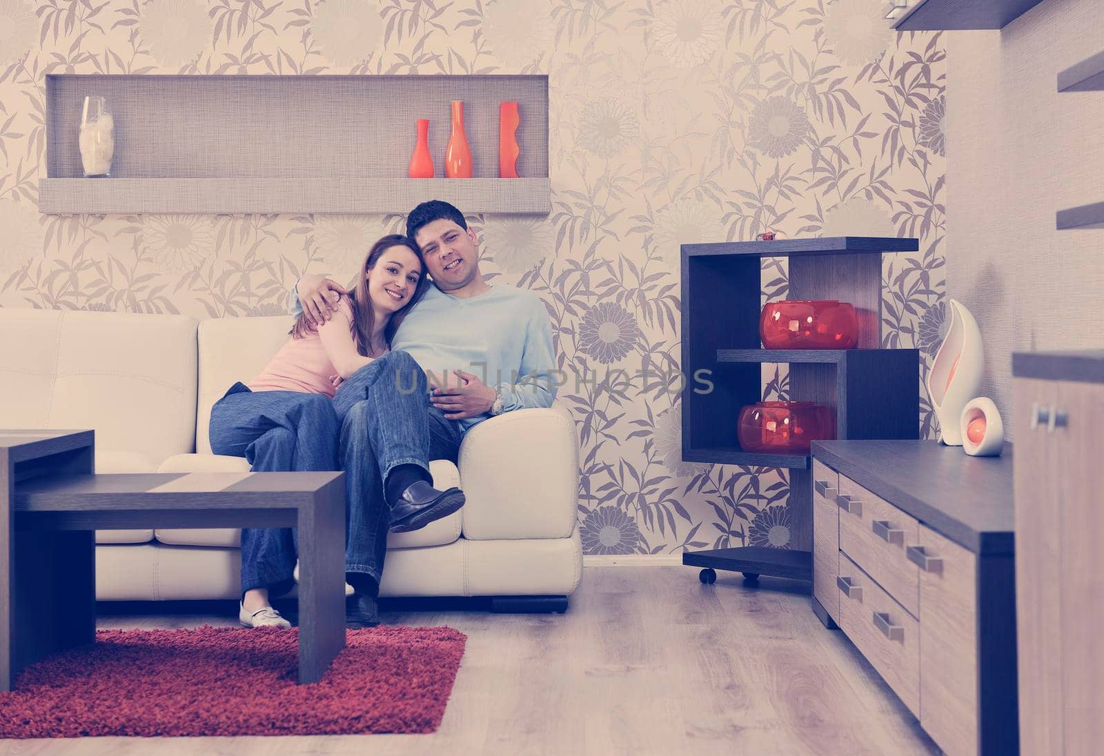 happy young couple relax at home in modern and bright living room 