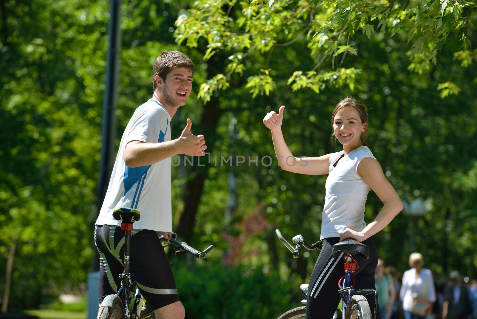 Happy couple ride bicycle outdoors, health lifestyle fun love romance concept