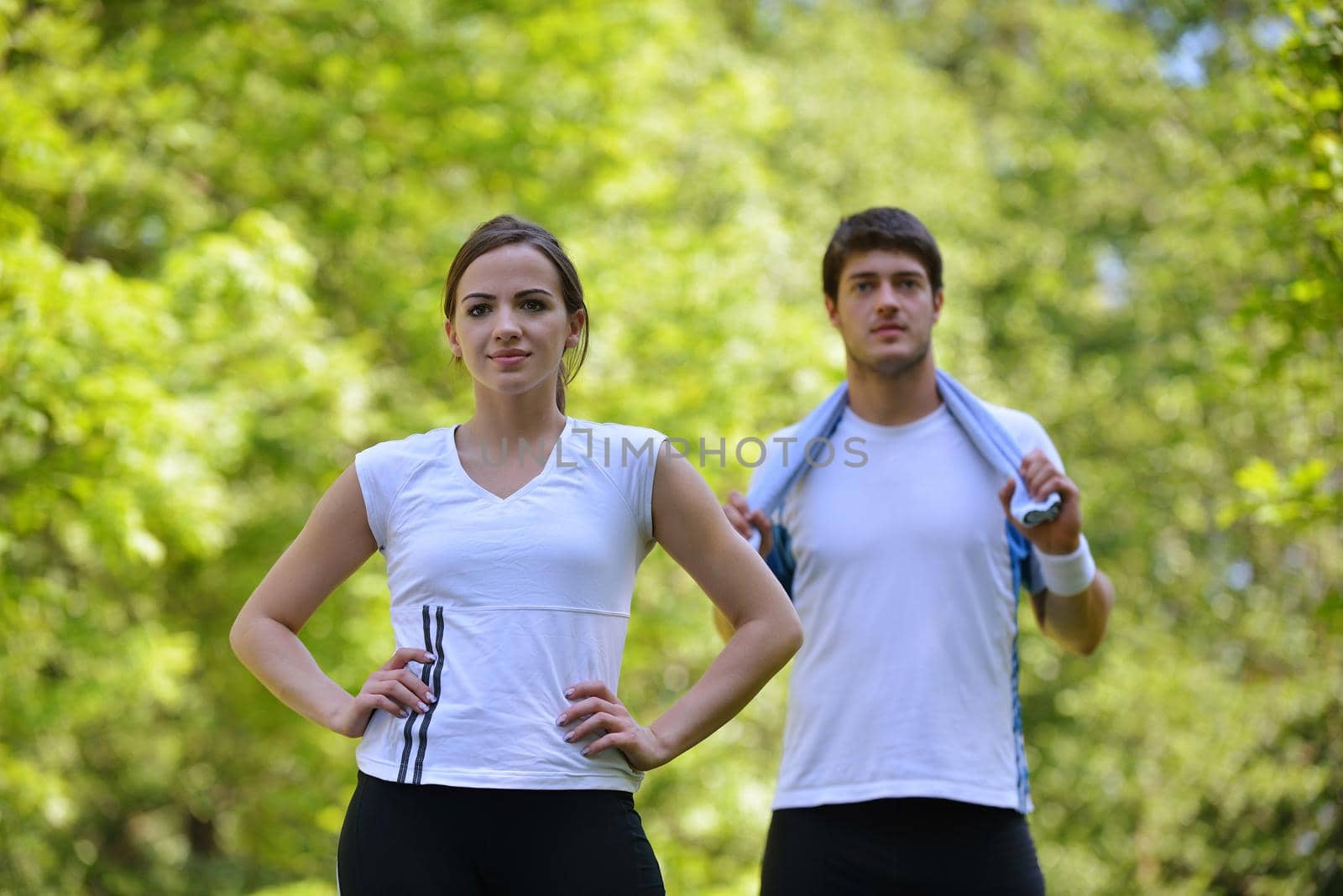 young health couple doing stretching exercise relaxing and warm up after jogging and running in park