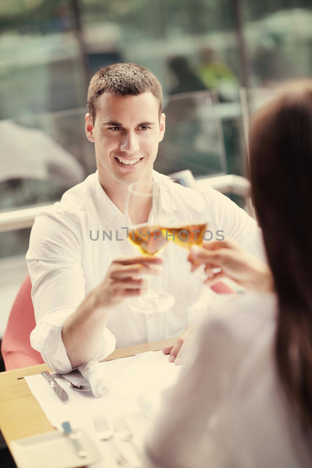 happy young couple having lanch at beautiful restaurant on by the sea on  beach