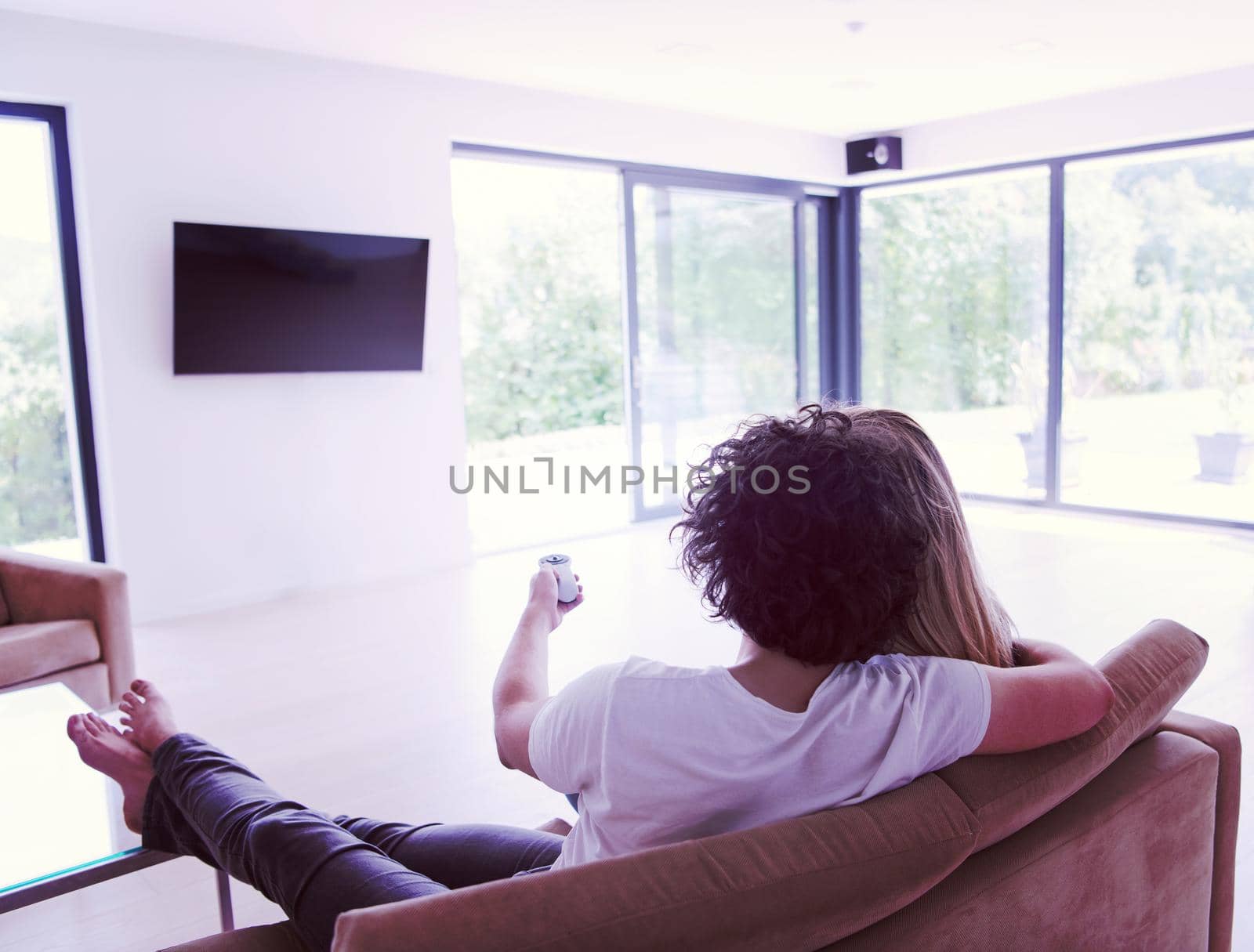 Rear view of couple watching television by dotshock