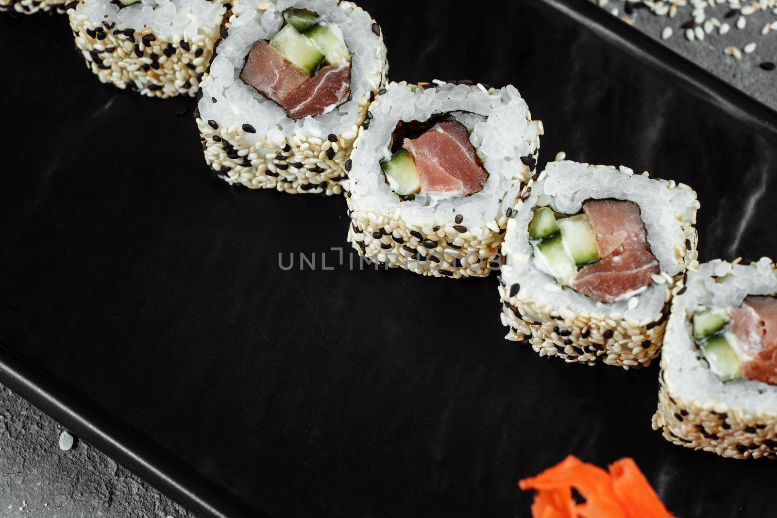 California roll sushi traditional Japanese rice food with salmon, avocado, cucumber, nori and sesame seeds by UcheaD