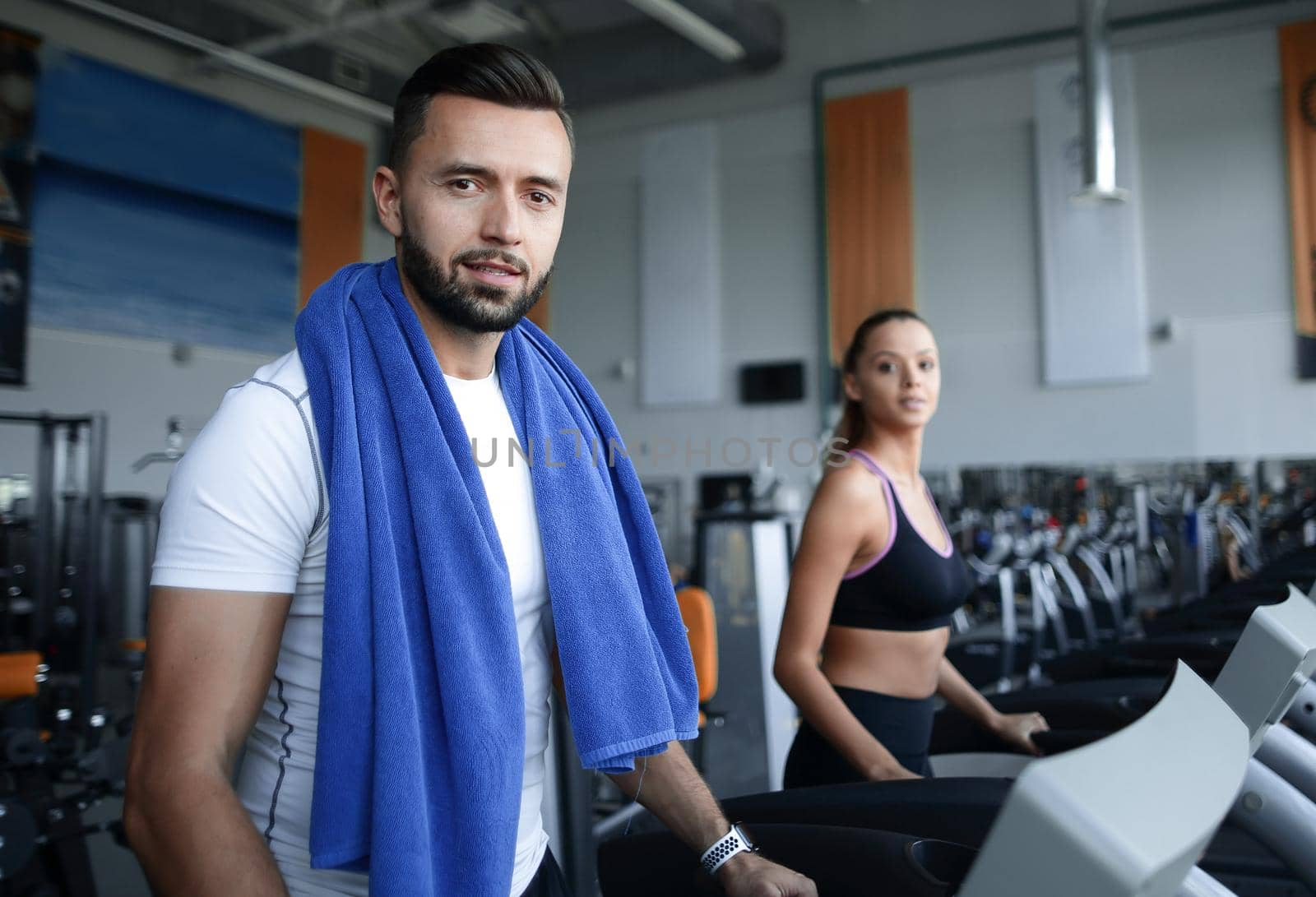 close up. an attractive man works in a modern gym by asdf