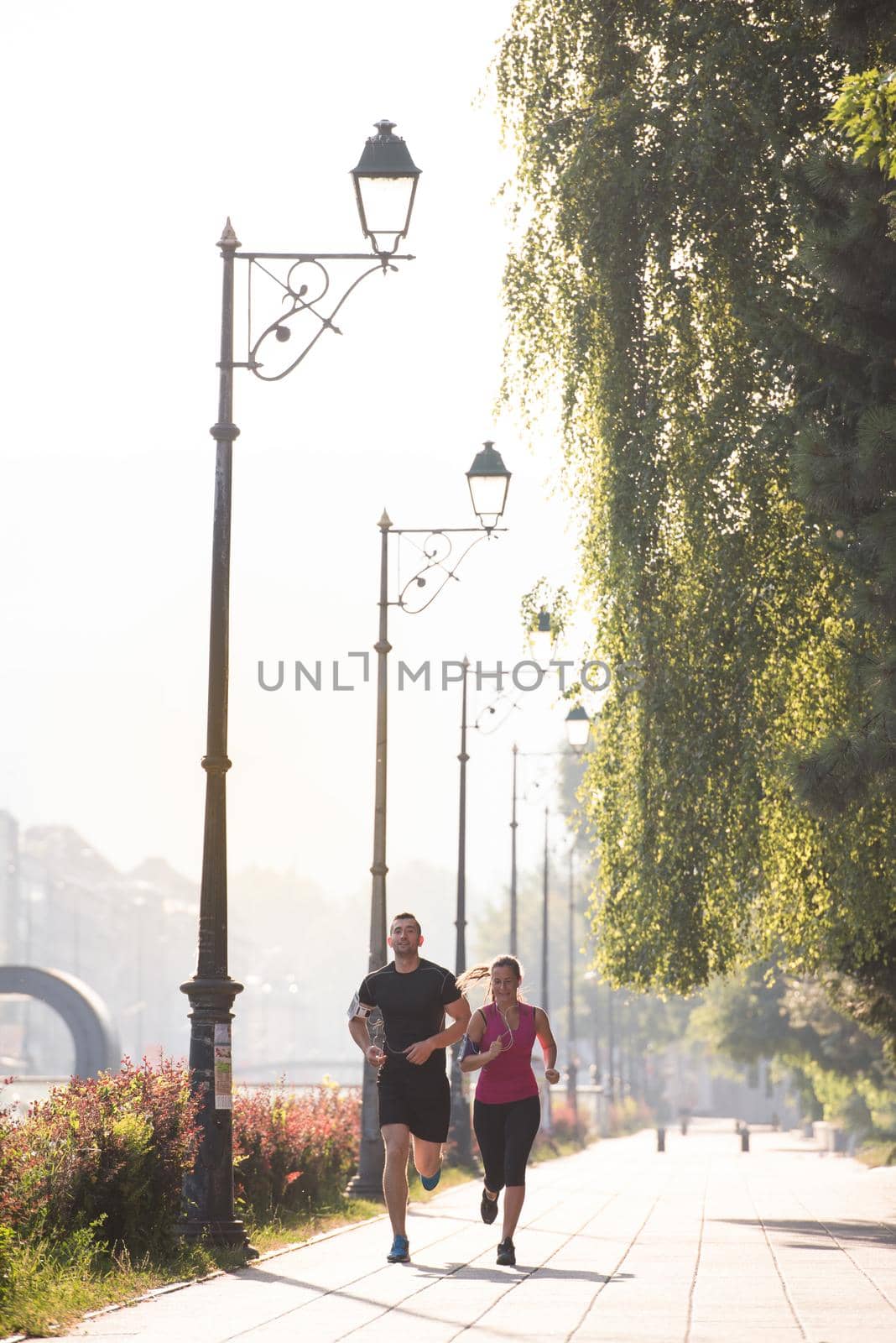 young couple jogging  in the city by dotshock