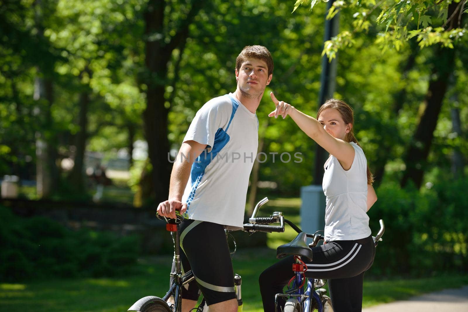 Happy couple ride bicycle outdoors, health lifestyle fun love romance concept