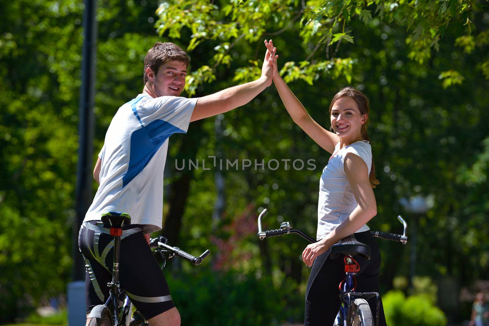 Happy couple ride bicycle outdoors, health lifestyle fun love romance concept