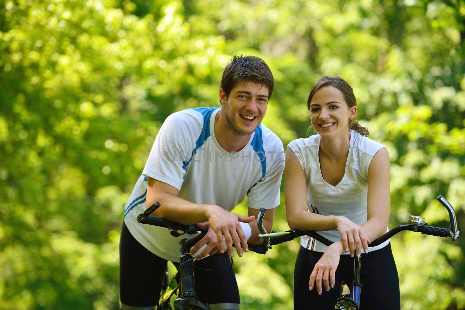 Happy couple ride bicycle outdoors, health lifestyle fun love romance concept