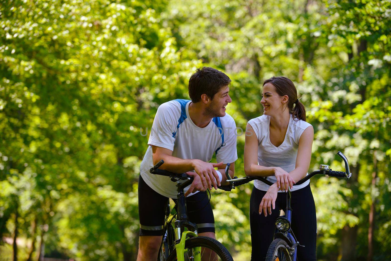 Happy couple ride bicycle outdoors, health lifestyle fun love romance concept