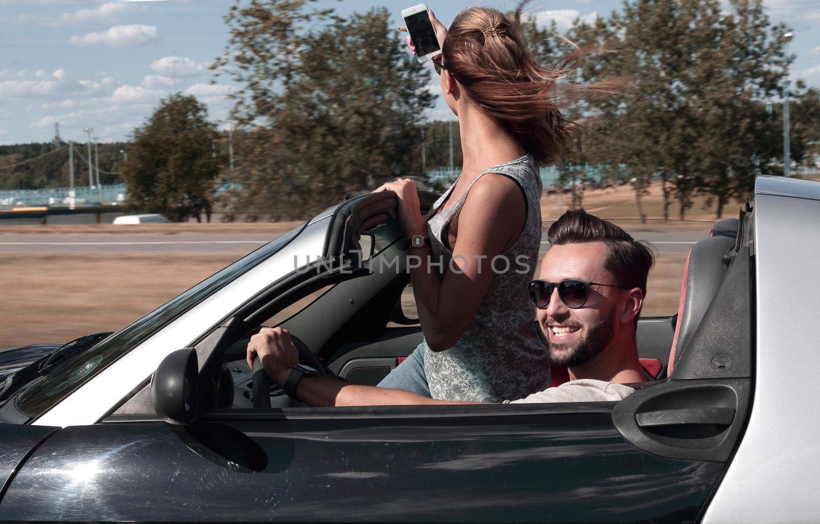 tourists taking a selfie travelling with car .people and technology