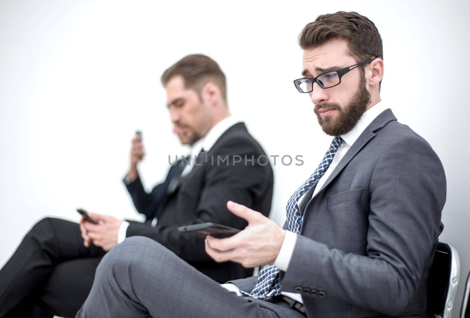 businessman with a smartphone sitting in the office reception.people and technology