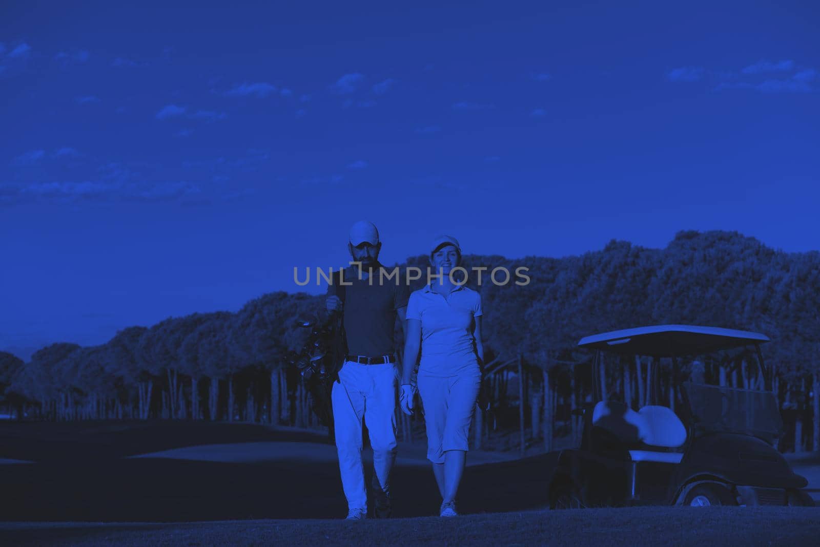 portrait of golfers couple on golf course by dotshock