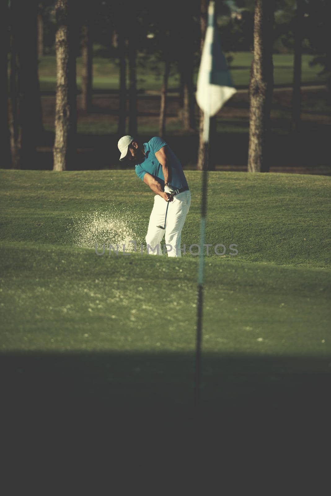 pro golfer hitting a sand bunker shot by dotshock