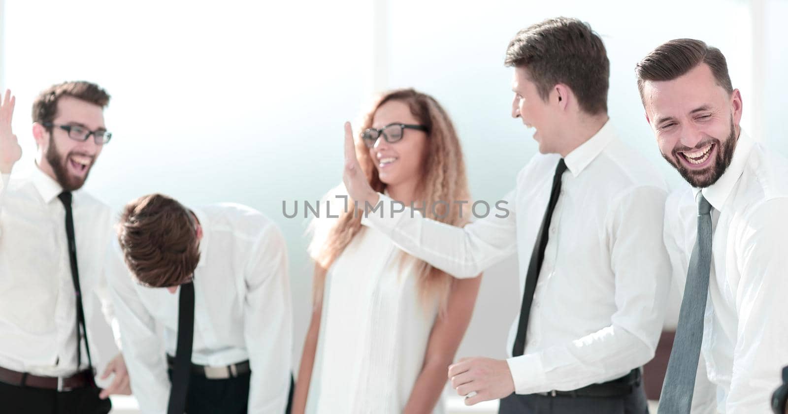 happy business team giving each other high five.the concept of teamwork