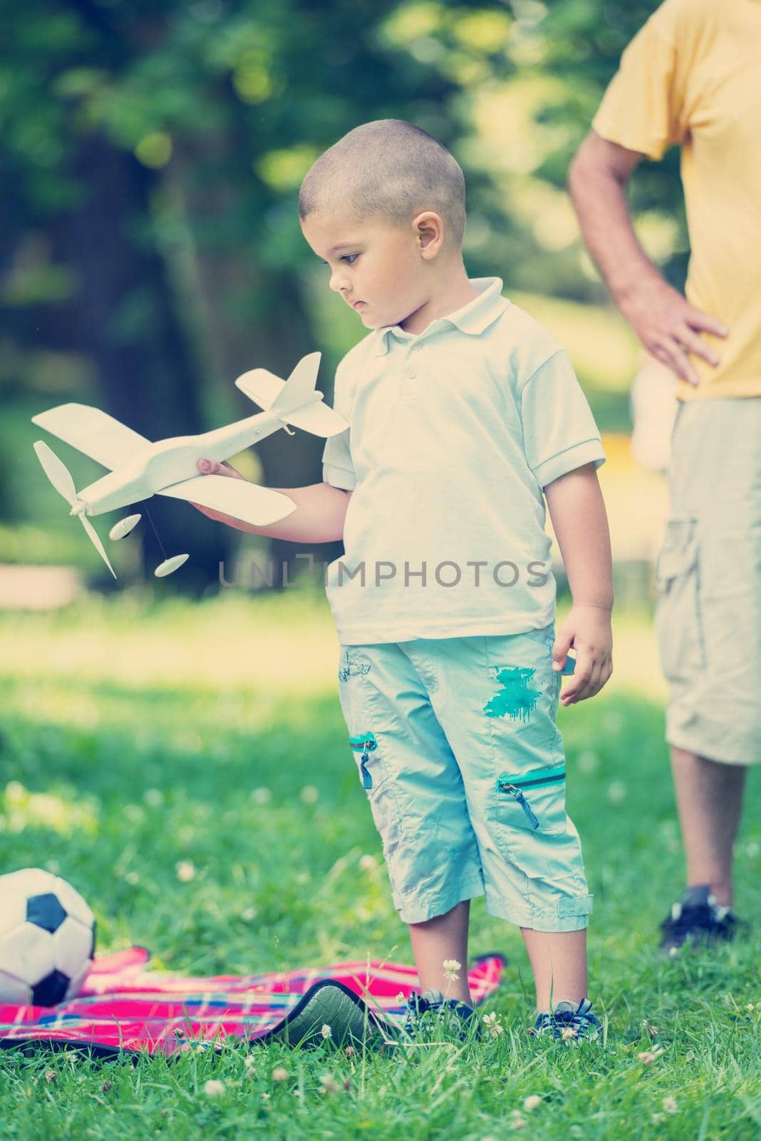 happy grandfather and child have fun and play in park on beautiful  sunny day