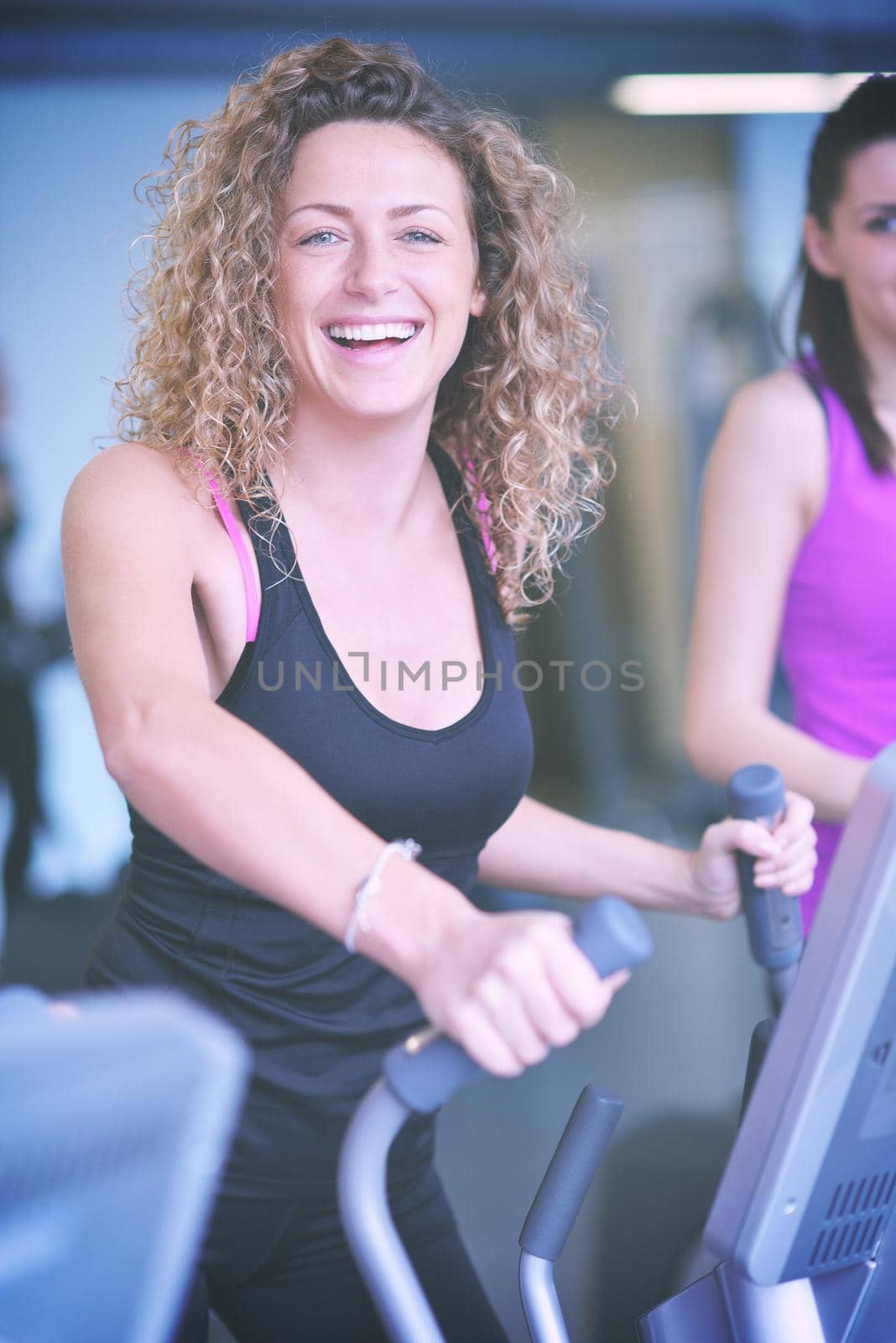woman exercising on treadmill in gym by dotshock