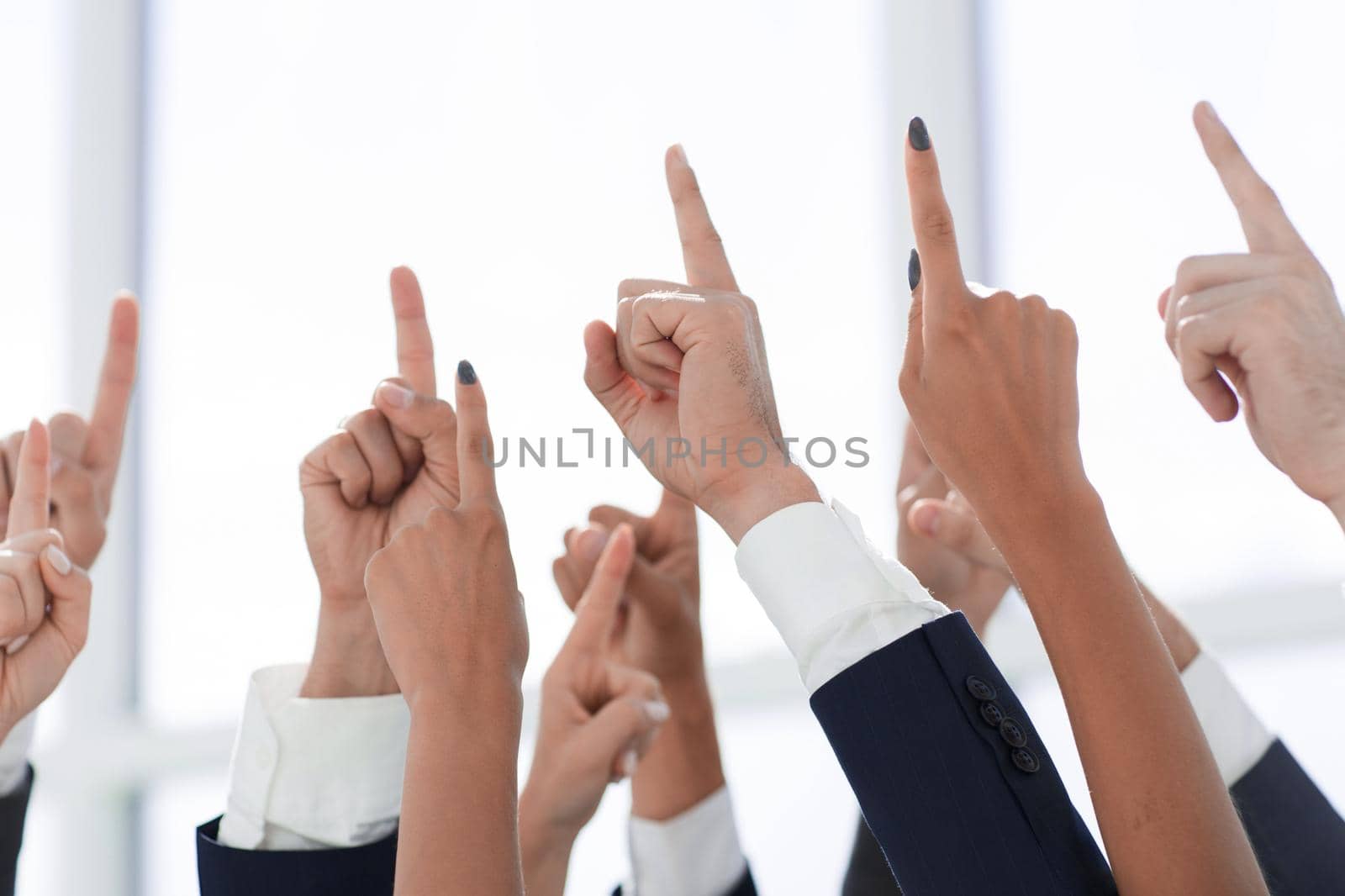 close up. a group of business people pointing up somewhere.photo with space for text