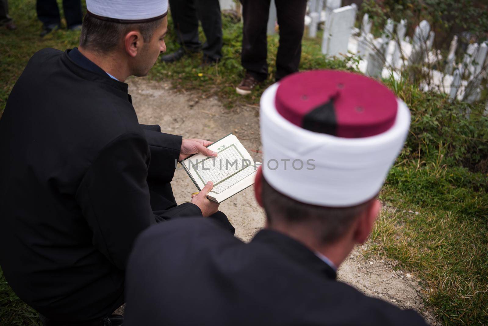 quran holy book reading by imam  on islamic funeral with white thumb stones graweyard background