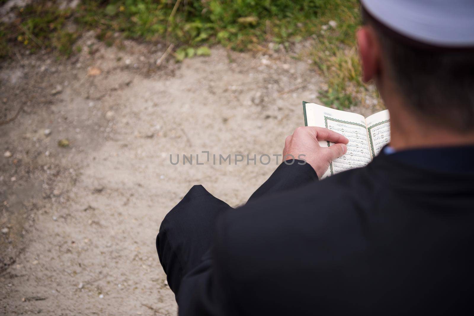 quran holy book reading by imam  on islamic funeral with white thumb stones graweyard background
