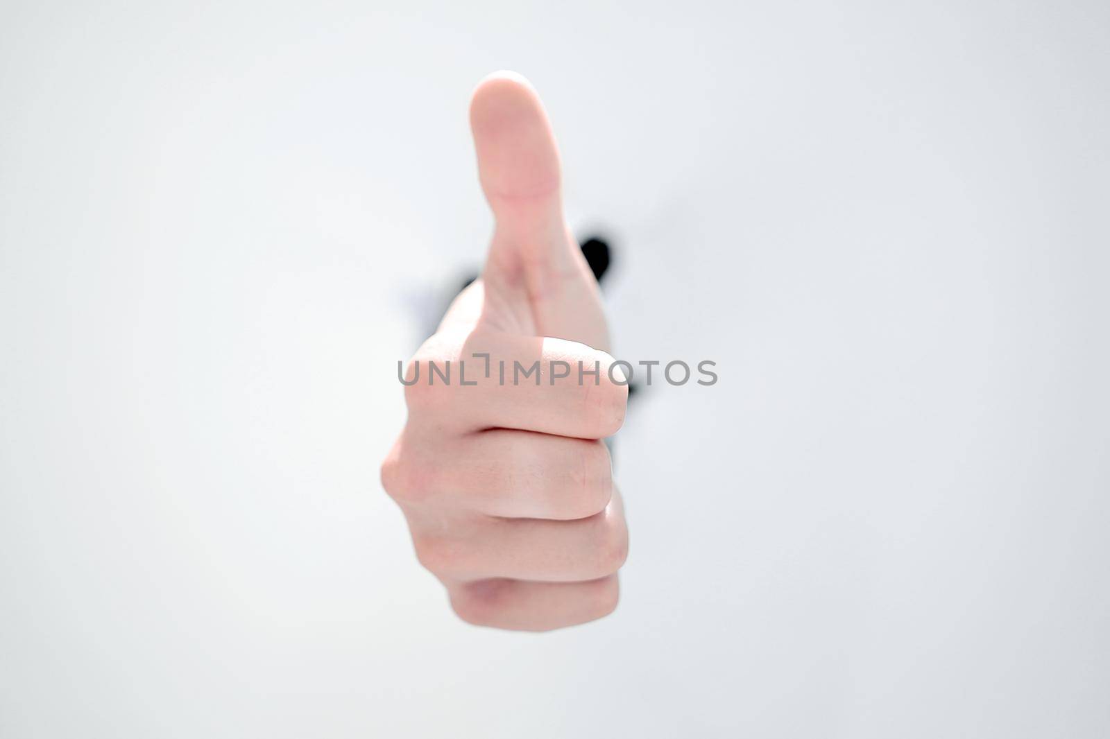 businessman breaking through the paper wall and pointing at you. by asdf