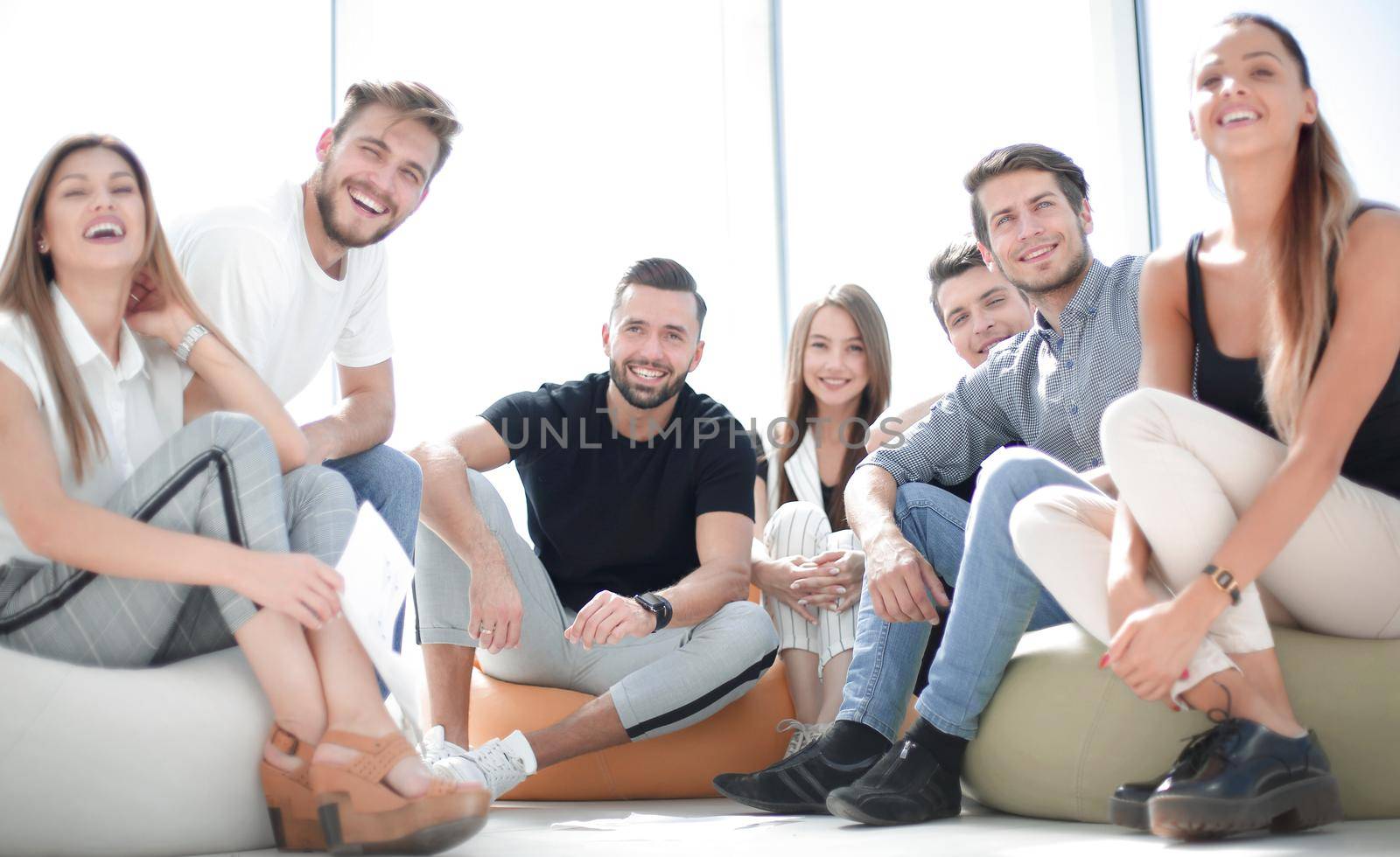 group of successful young people sitting in a new office by asdf