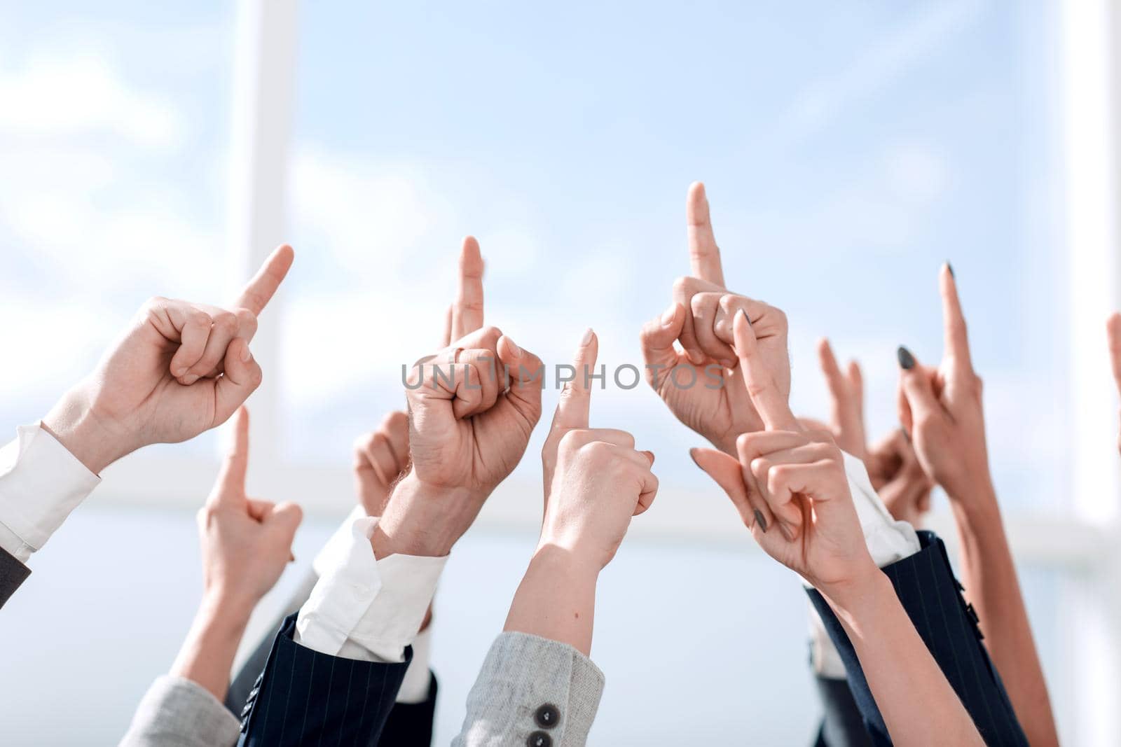 close up. a group of business people pointing up.photo with space for text