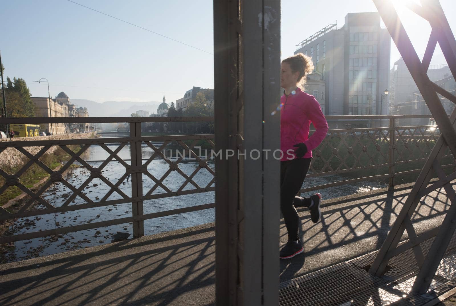 sporty woman jogging on morning by dotshock