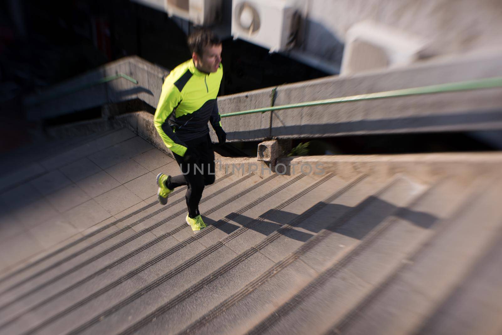 man jogging  at cold autumn  mornigng on steps