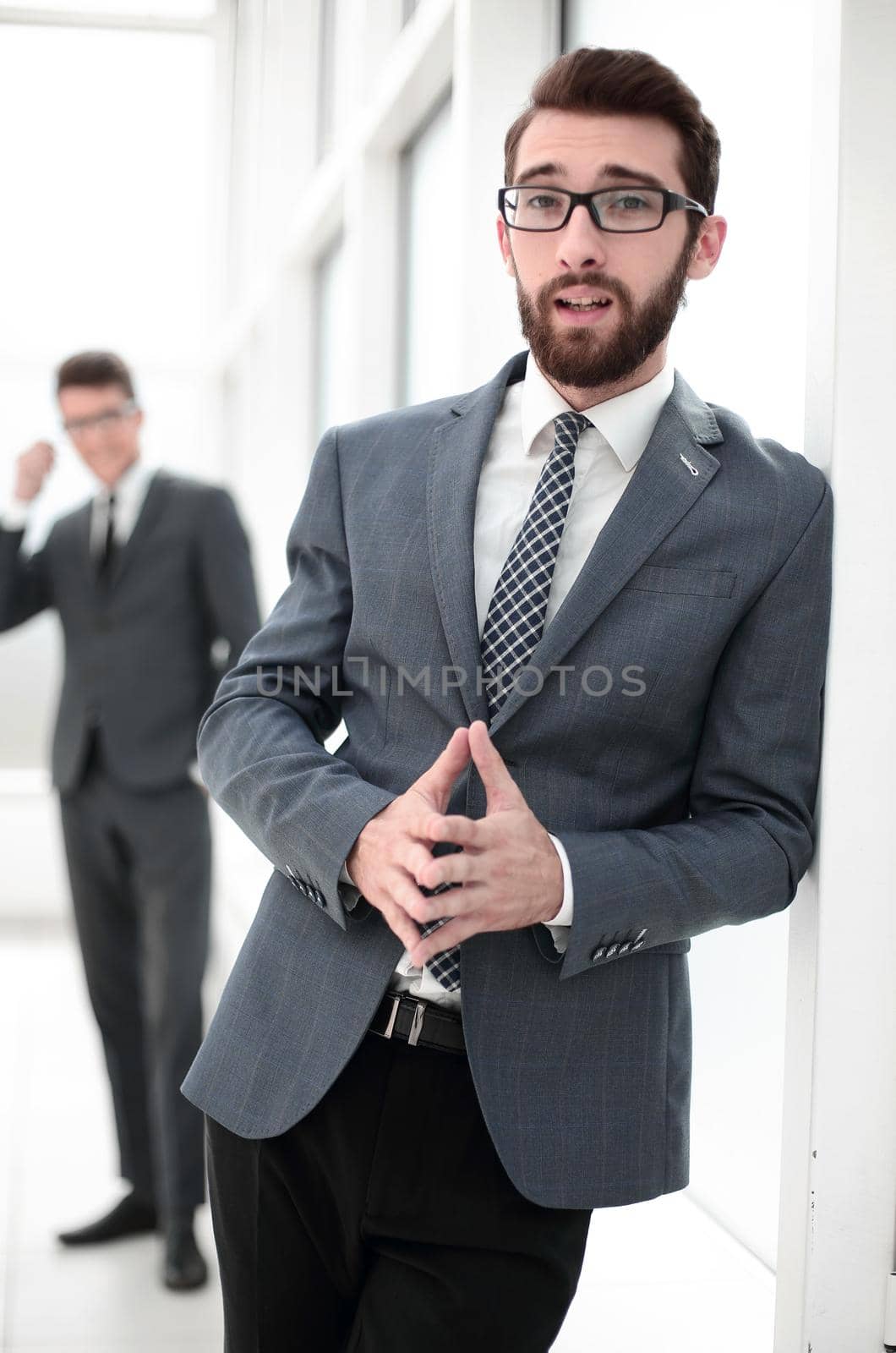 close up.smiling businessman standing in the office by asdf