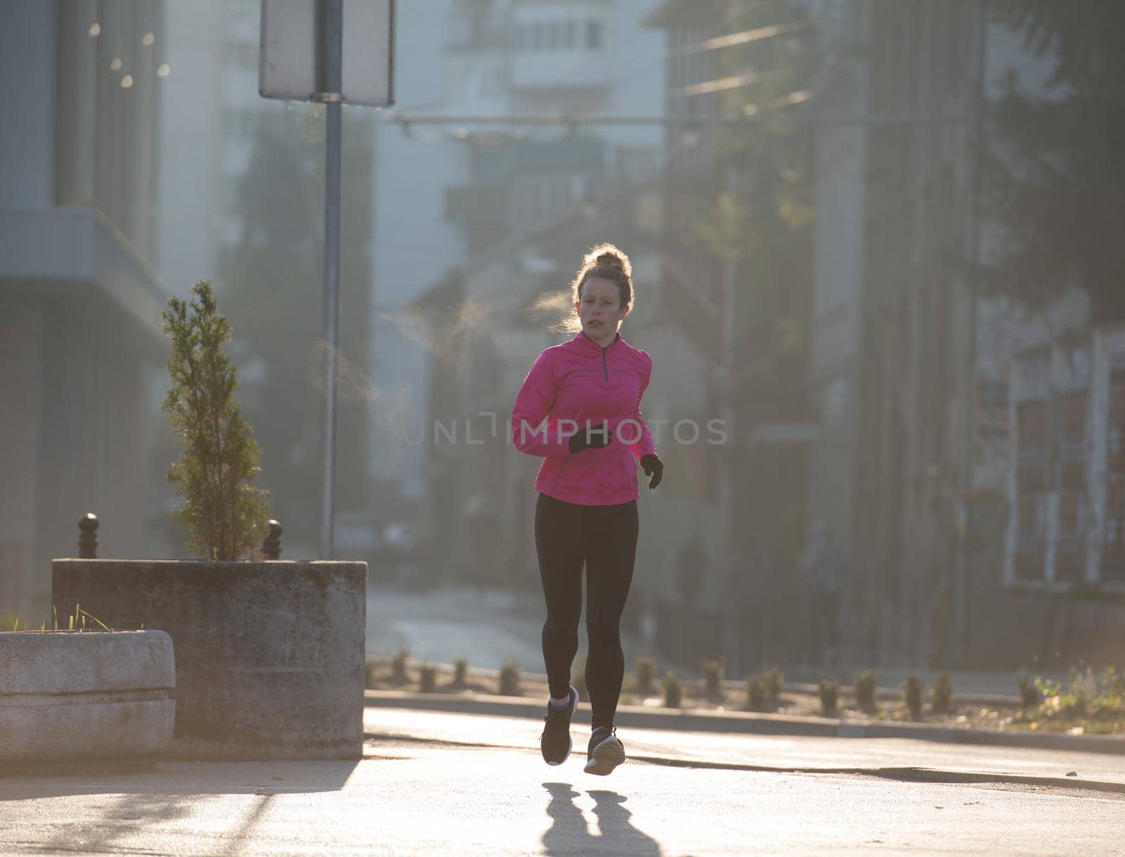 sporty woman jogging on morning by dotshock