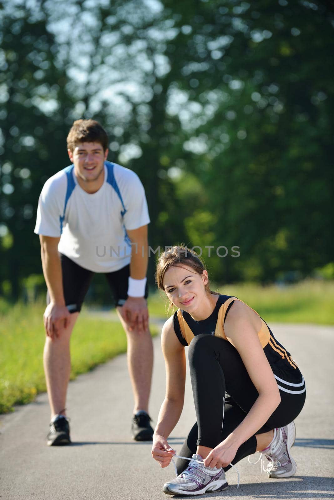 Young couple jogging in park at morning. Health and fitness concept