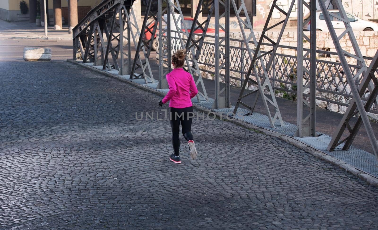 sporty woman jogging on morning by dotshock