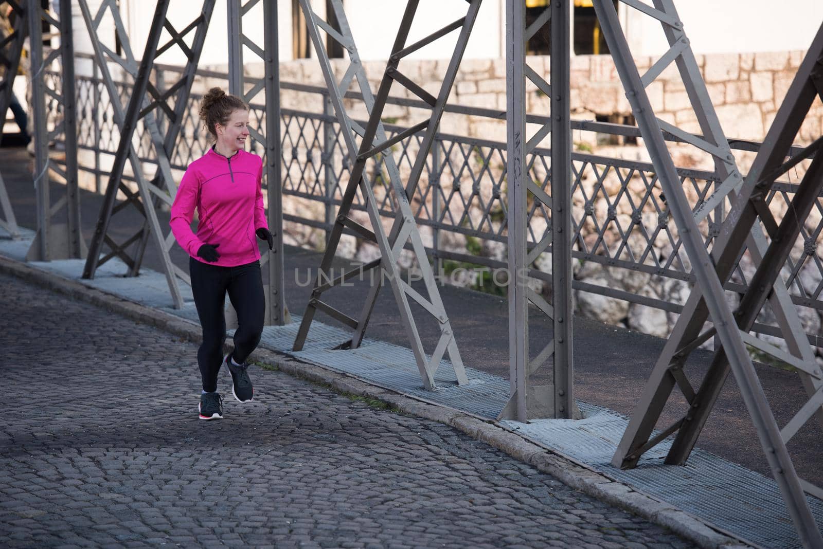 sporty woman jogging on morning by dotshock