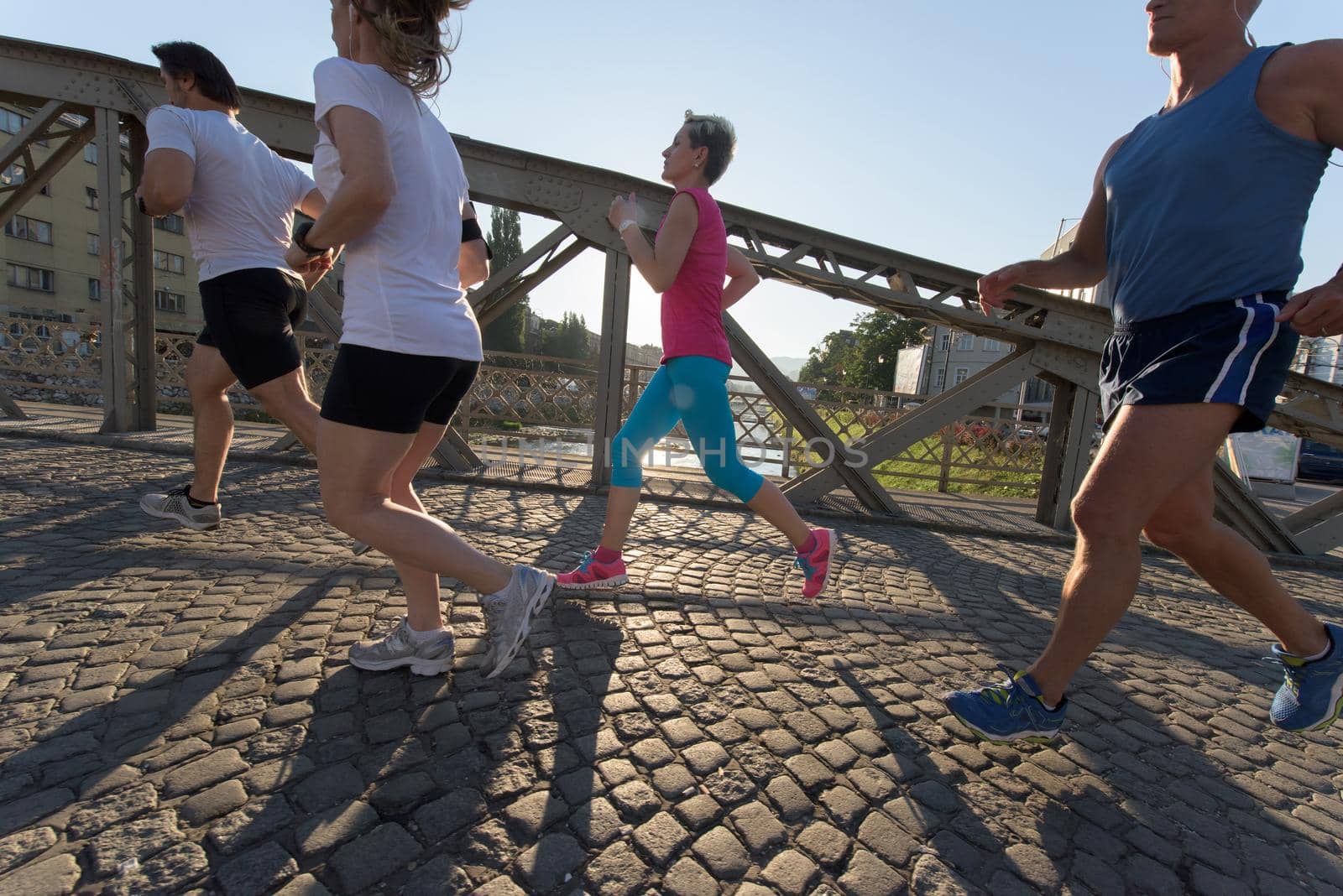 people group jogging  runners team on morning  training workout with sunrise in background